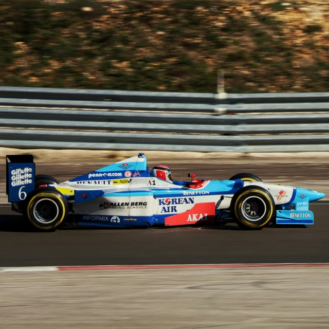 the racing car is driving along the track