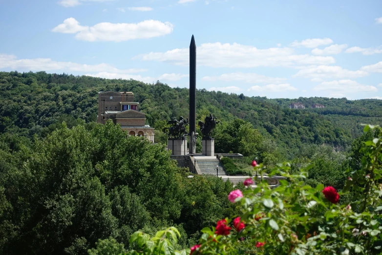 the statue has four pillars surrounded by trees