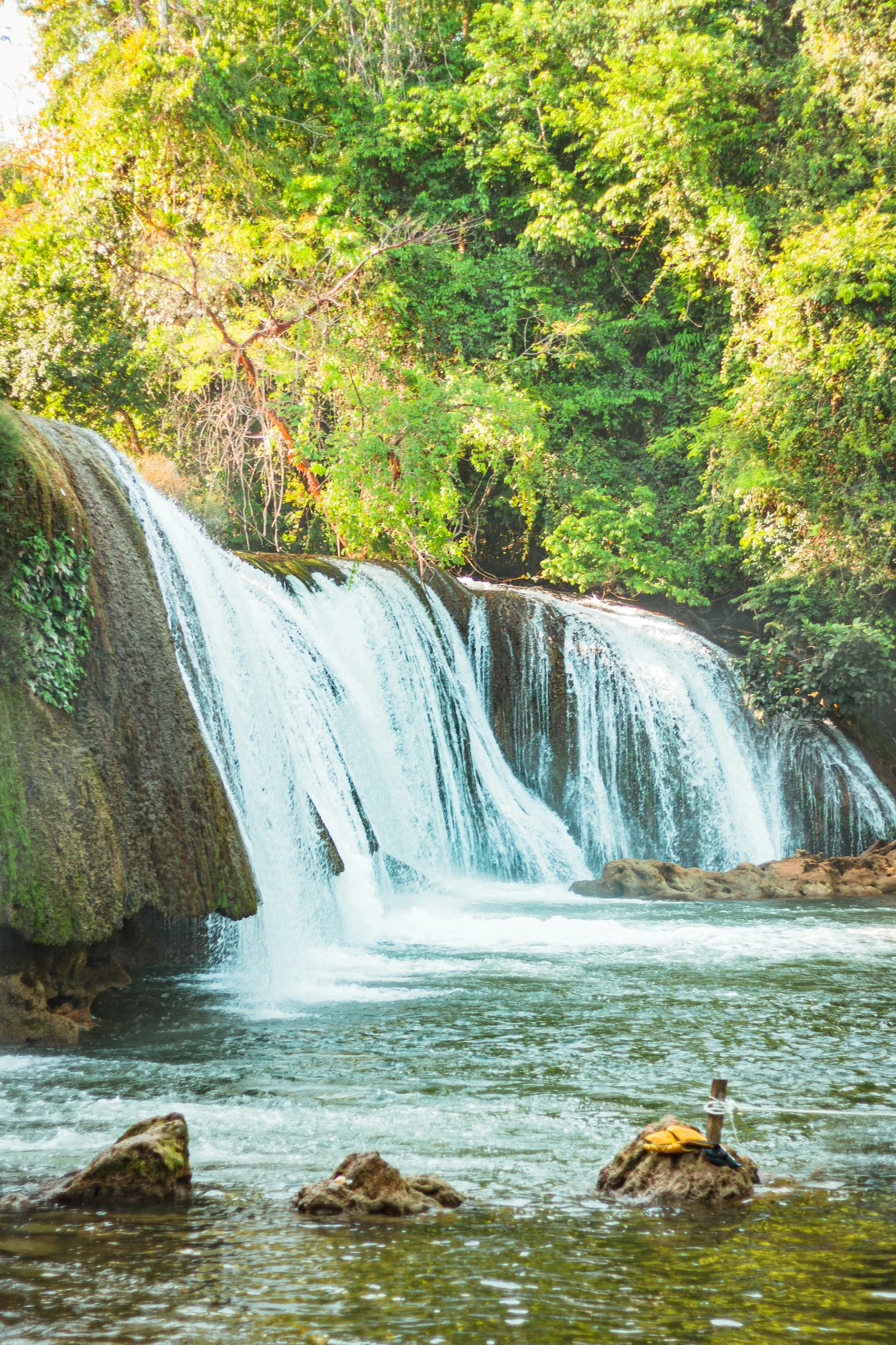 a large waterfall that is in the middle of a jungle