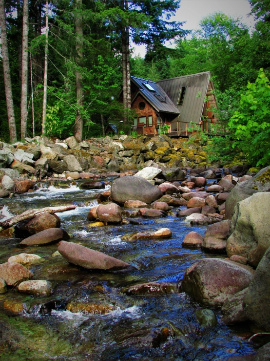 a house is in the background with water flowing