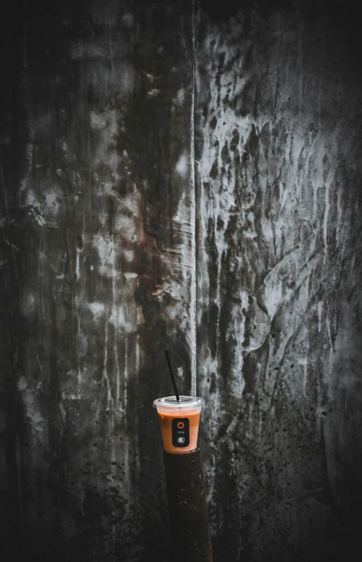 a cup that is on the side of a stone wall