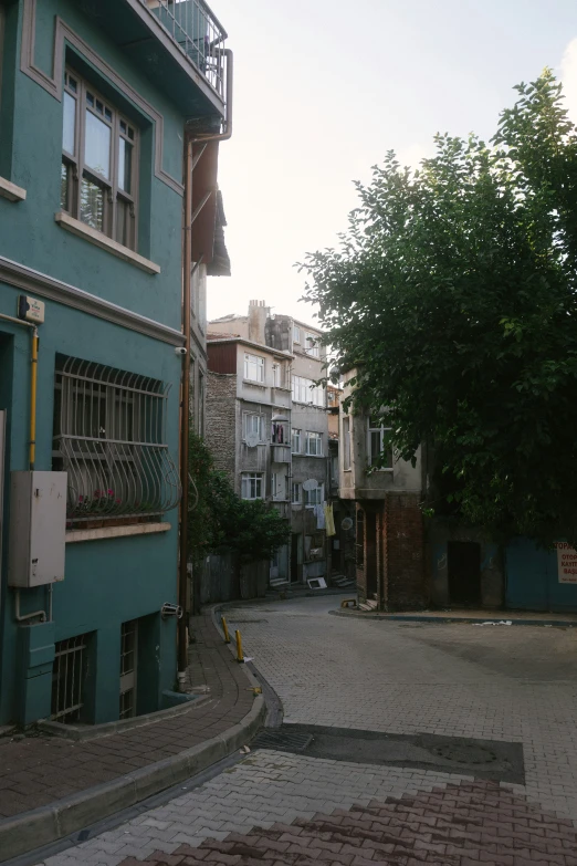 a couple of green buildings on a street