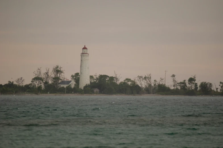 a lighthouse sitting on top of a large island