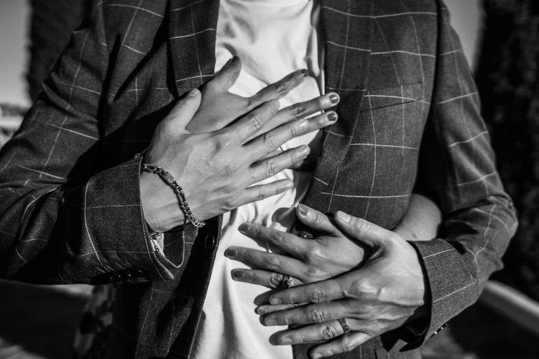 woman in blazer is displaying hand gestures while wearing necklace