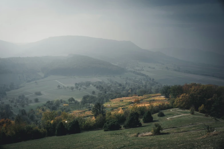 foggy mountains surround the valley in the background