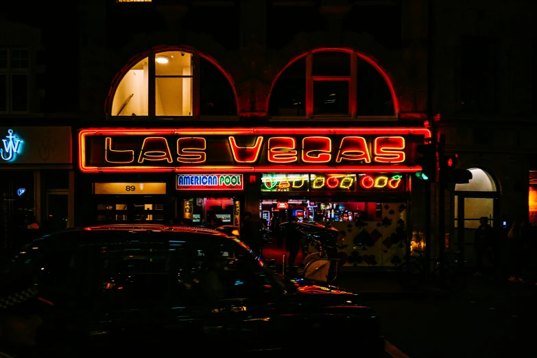 a building with neon lights on a dark night