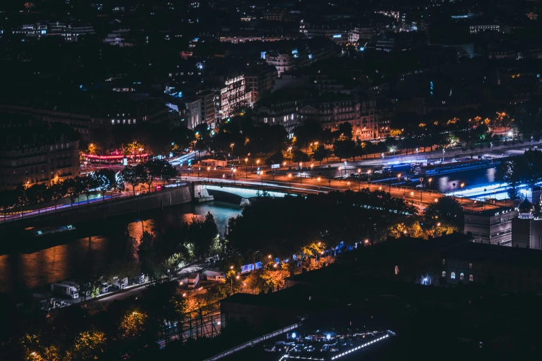an aerial view of lights along a river at night