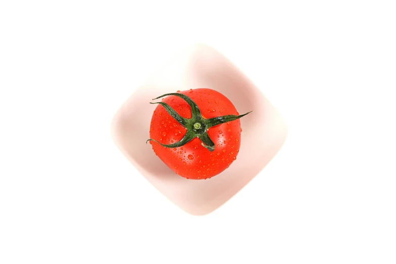 a tomato is seen in the bowl on a table