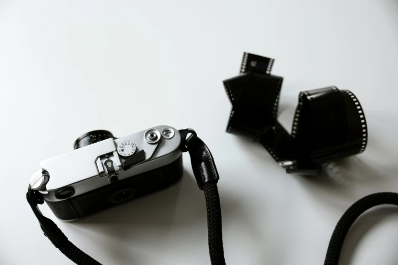 a couple of cameras sitting on top of a white surface