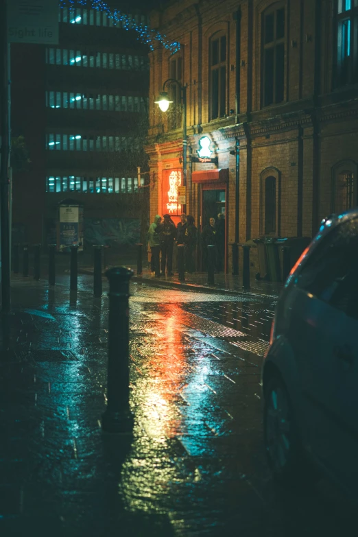 there is a building in the background and people on a sidewalk