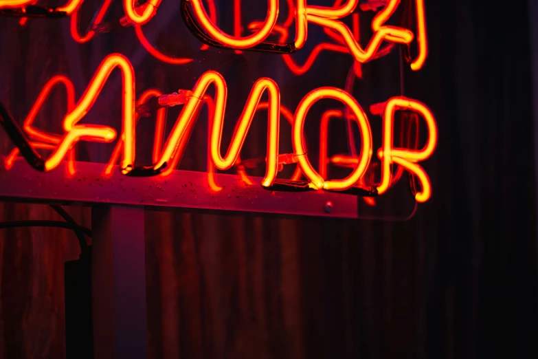 an illuminated neon sign advertising an art show