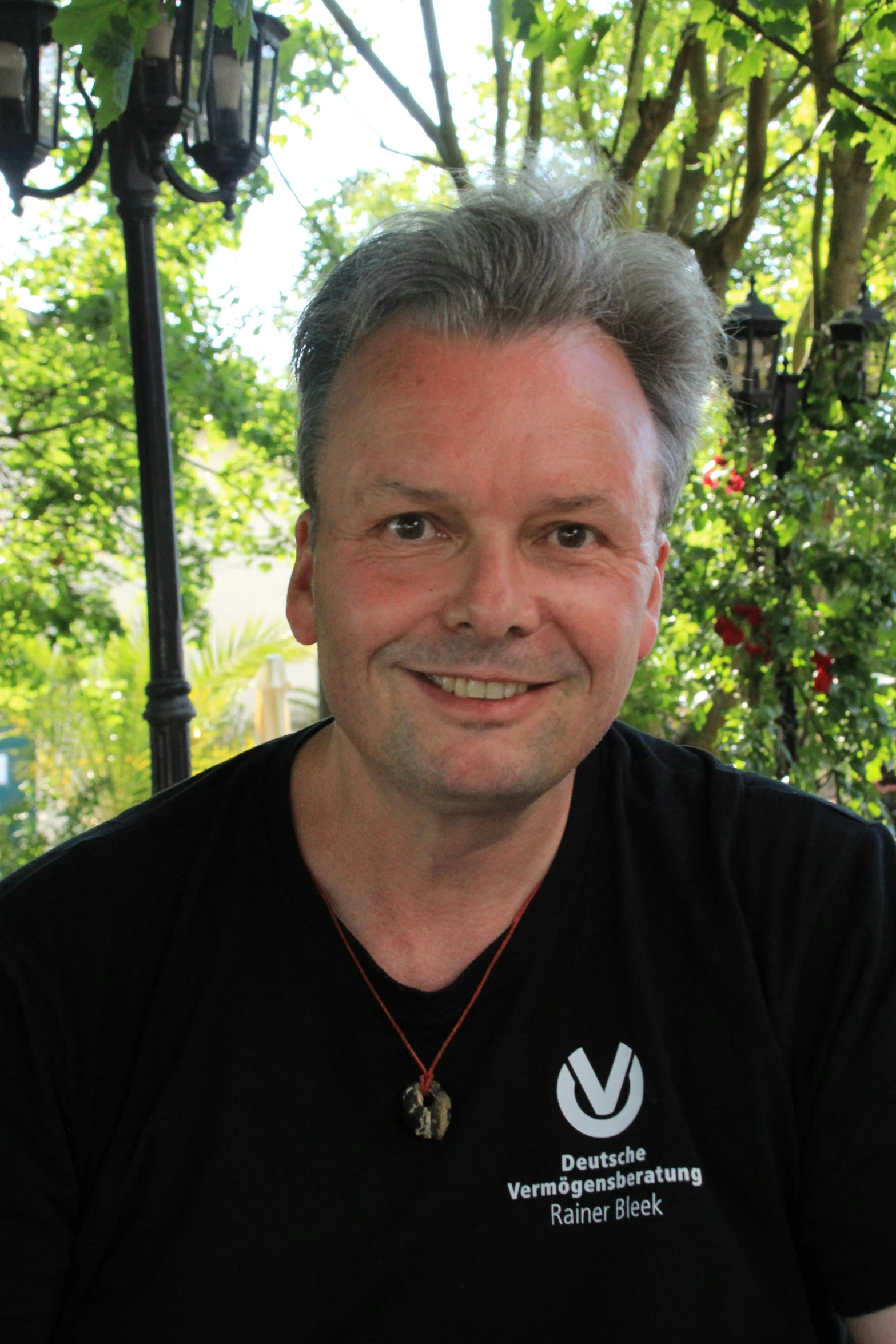 a man sitting outside smiling for the camera