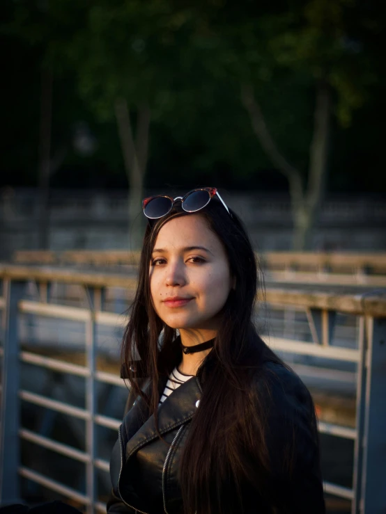 a woman poses for a portrait wearing some sunglasses