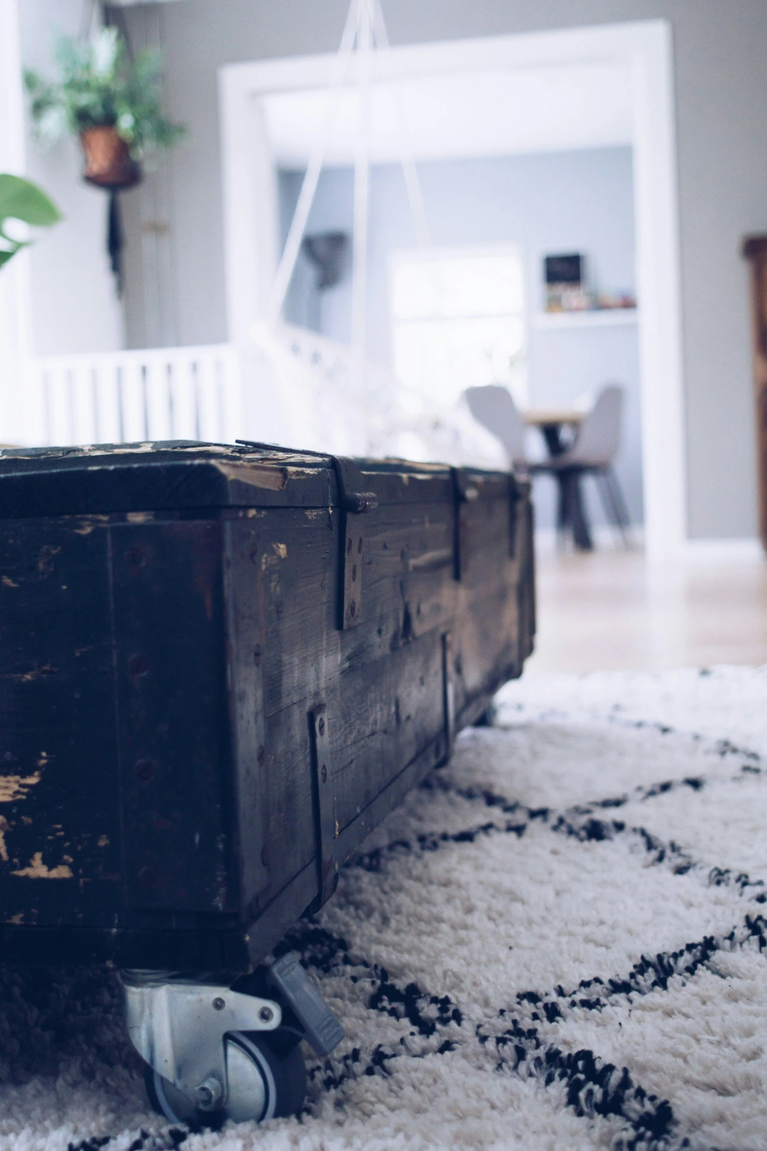 a small wooden trunk sitting on top of a rug