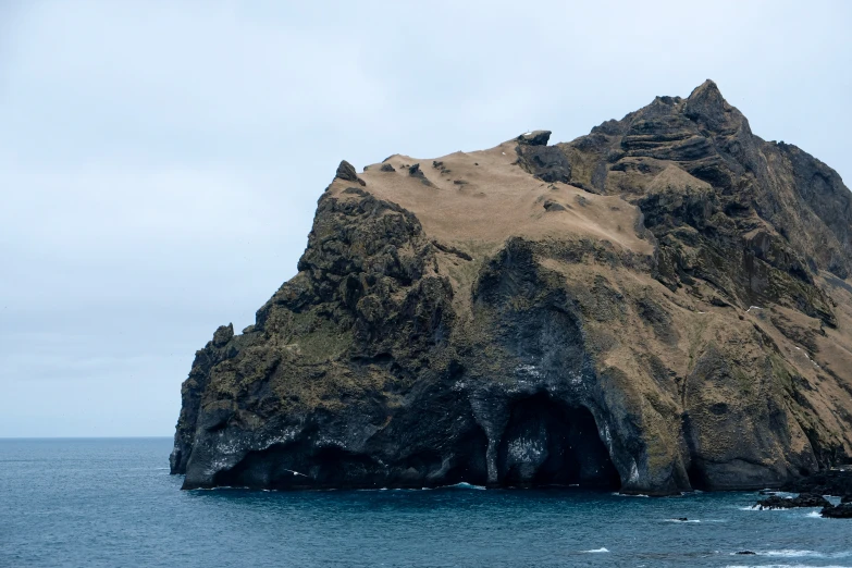 a large rock out in the middle of the ocean