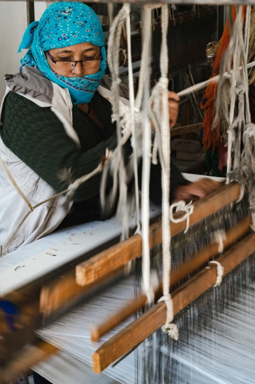 a woman knitting on the loom