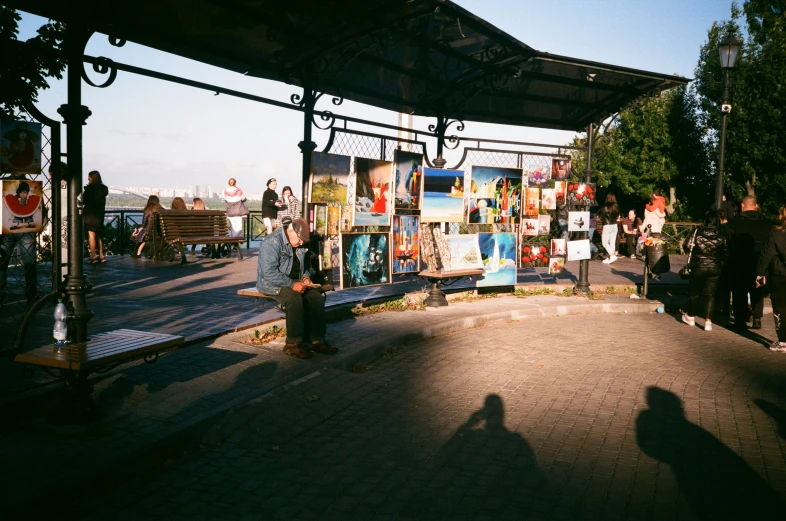 a group of people standing around next to a train station