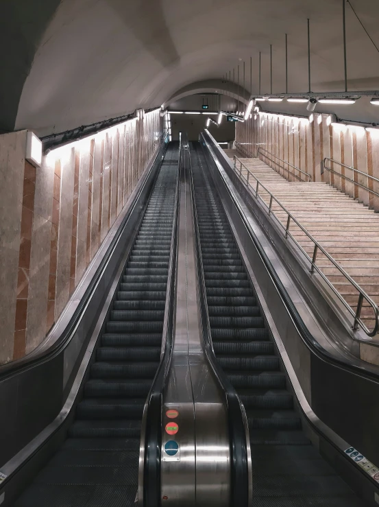 an escalator leads down to the platform for people