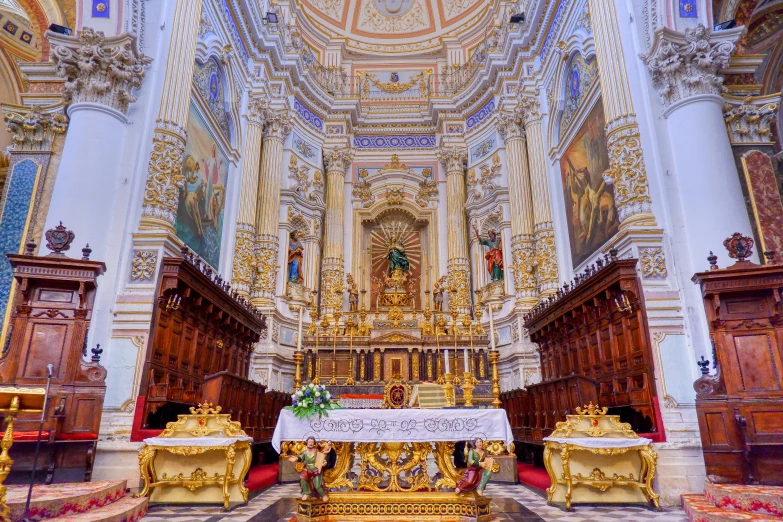 the altar is surrounded by ornate white columns and gold accents