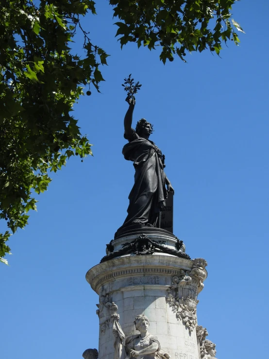 a statue is shown on top of a stone pillar