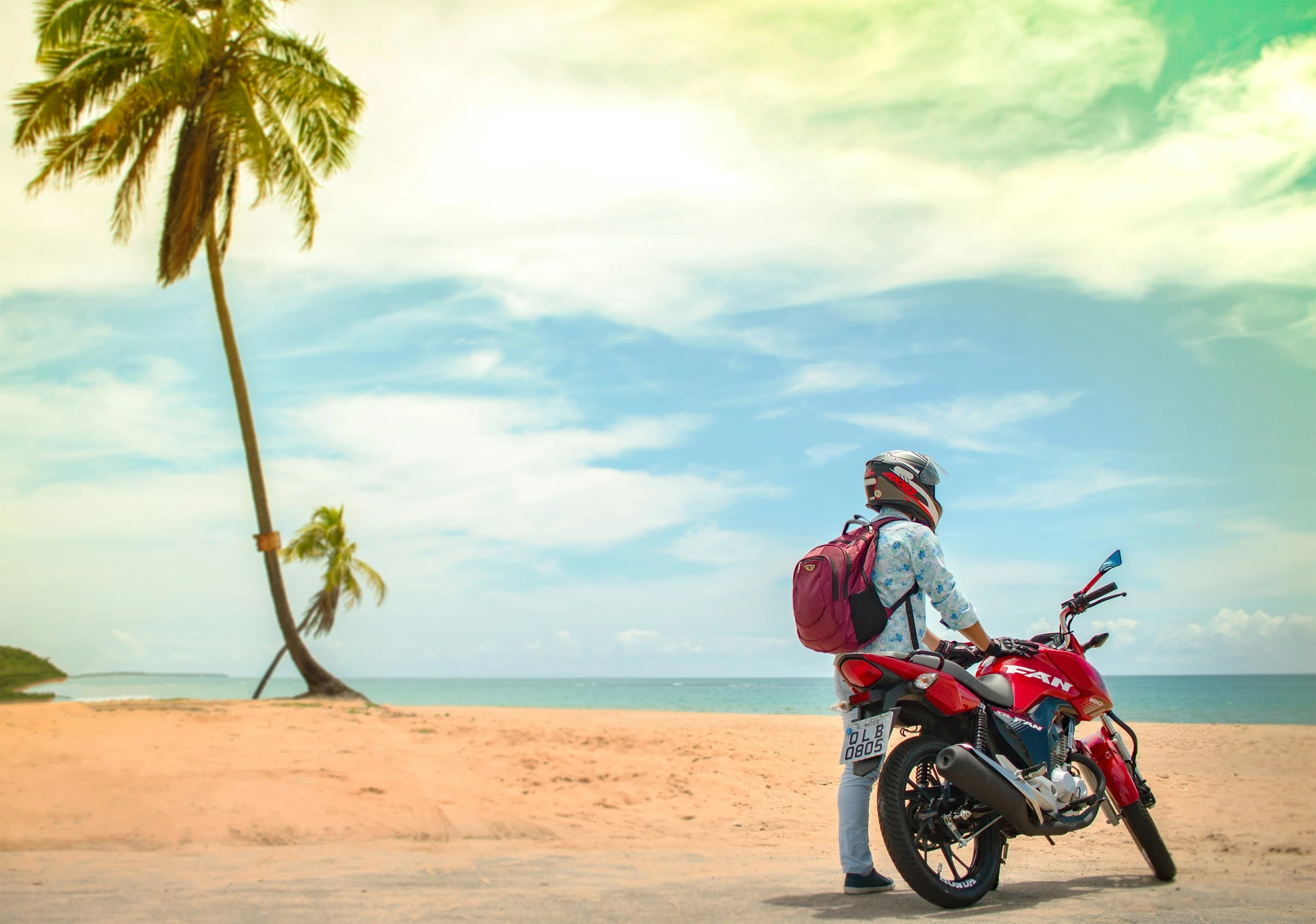 a man in a red jacket sitting on a motorcycle