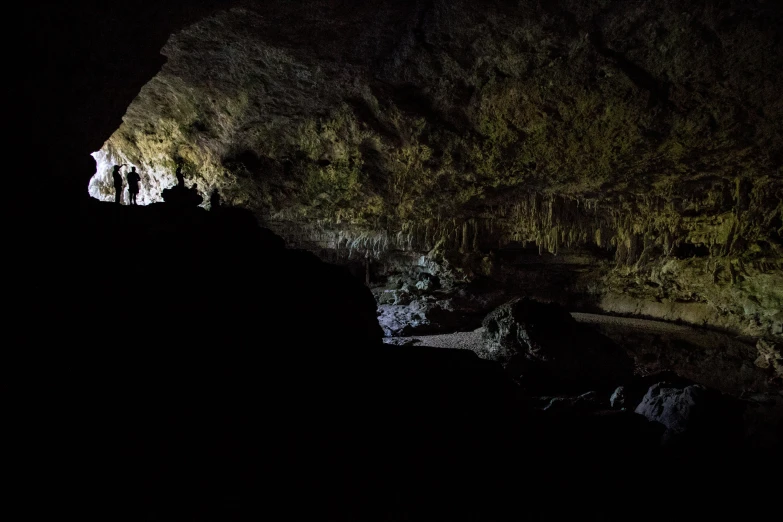 cave with people inside at night with no lights