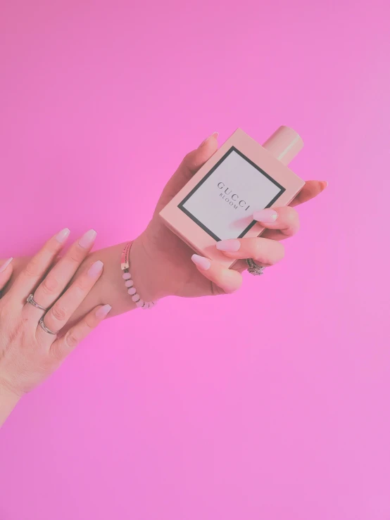 woman holding a pink smart device with a white screen