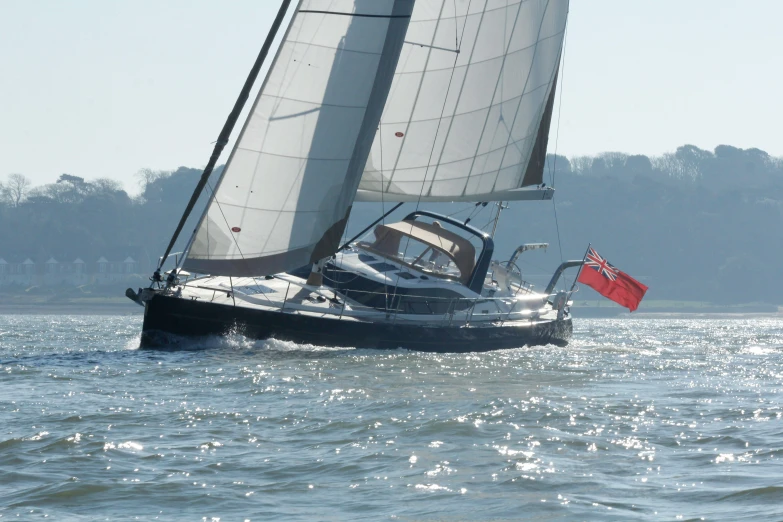 a small sail boat sailing on a large body of water