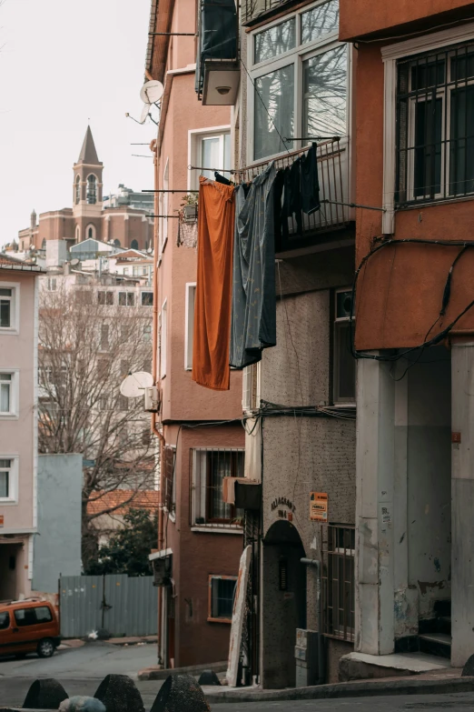 clothes hang from a clothesline in the middle of an urban neighborhood