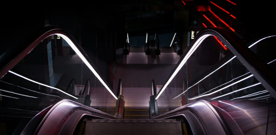 a view of a modern escalator in a dark place