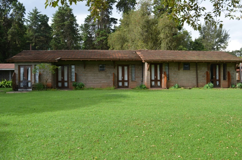 a house on a farm with trees and grass