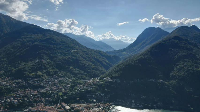 a boat traveling through the water in front of mountains