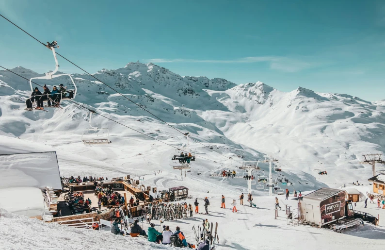 a ski lift with people skiing down it