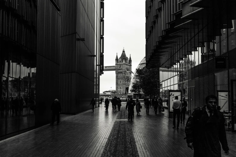 people are walking in the street in front of an architectural building