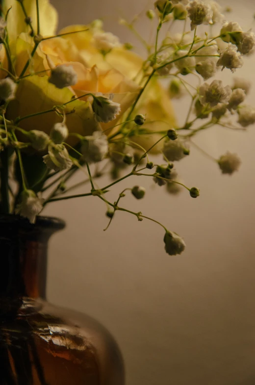 a vase filled with lots of white flowers