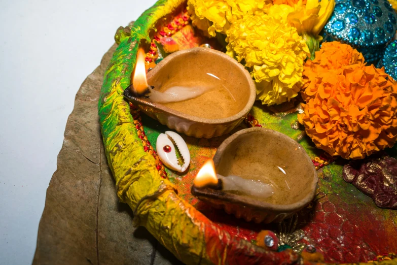 a plate with three bowls on it and decorations in the center