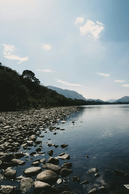 there is a large body of water next to a rocky shore