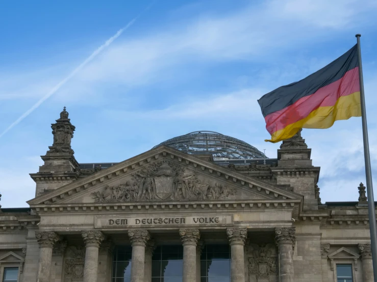 a german flag is flying at half mast above a building