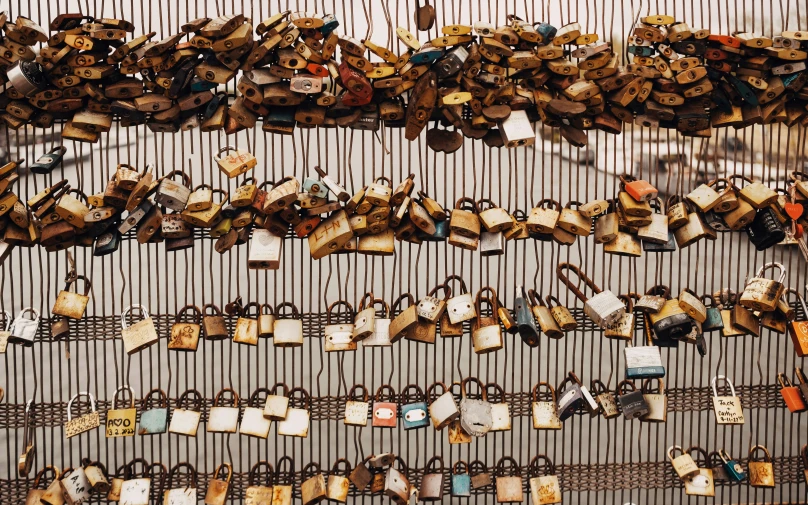 there are hundreds of key locks hung on a wall