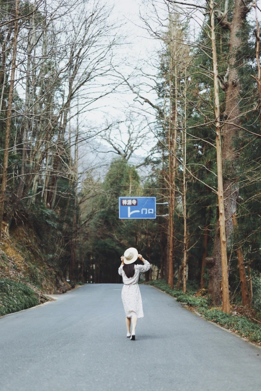 the woman is trying to stop traffic on the road