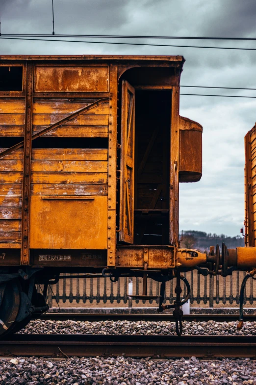 two wooden containers on wheels on a train track