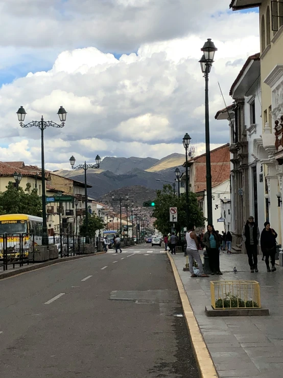 an empty road surrounded by buildings and cars