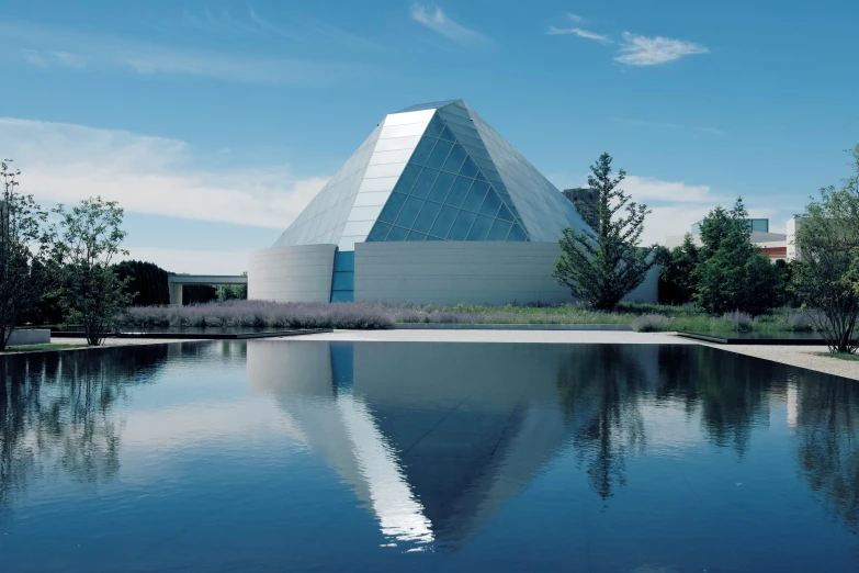 large building sitting next to a lake in a park