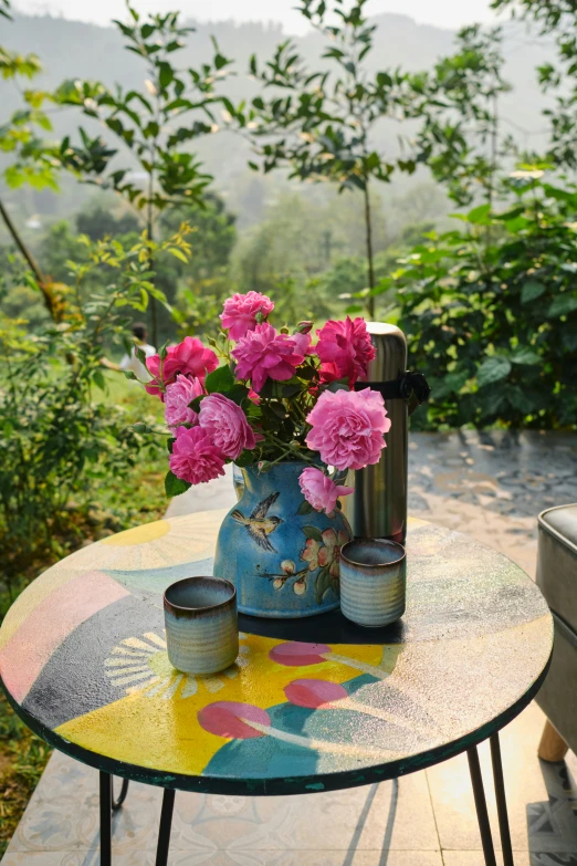 some pink flowers on a table outside