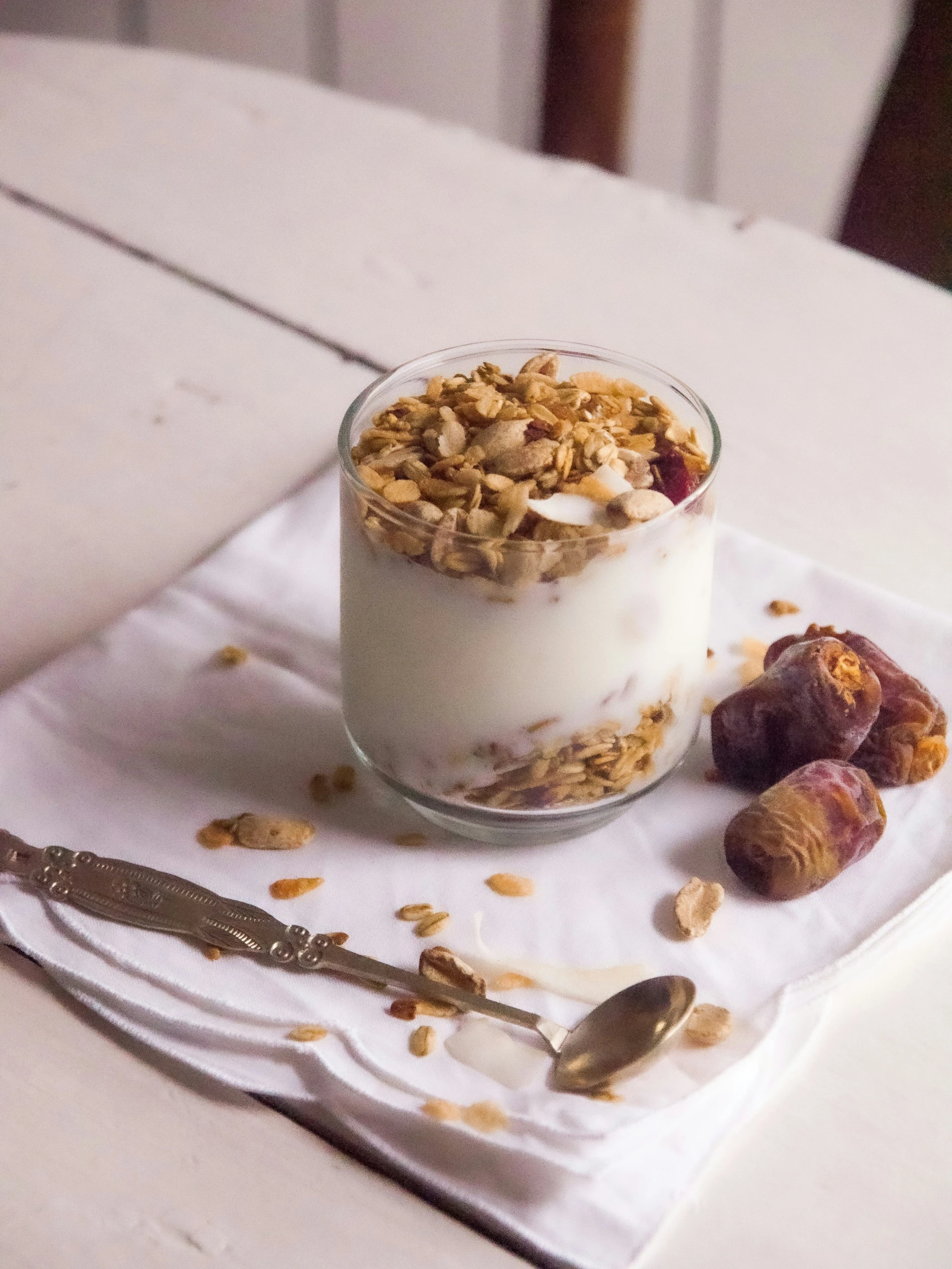 two bowls sitting on a napkin with granola and fruit