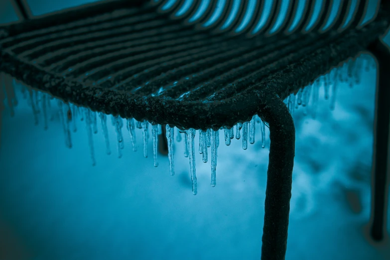 a bench with ice on top of it under water