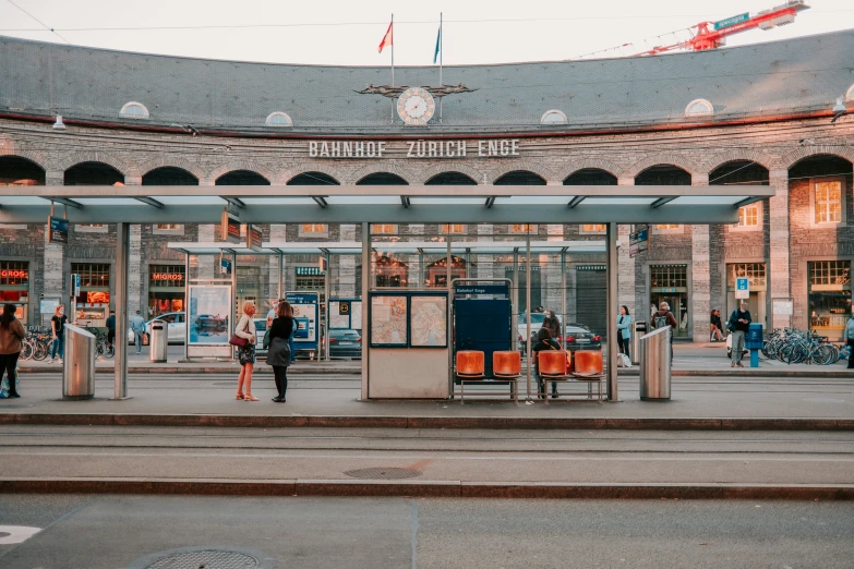 the people are waiting on the train station platform