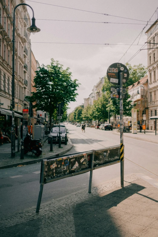 an empty street filled with traffic next to large buildings