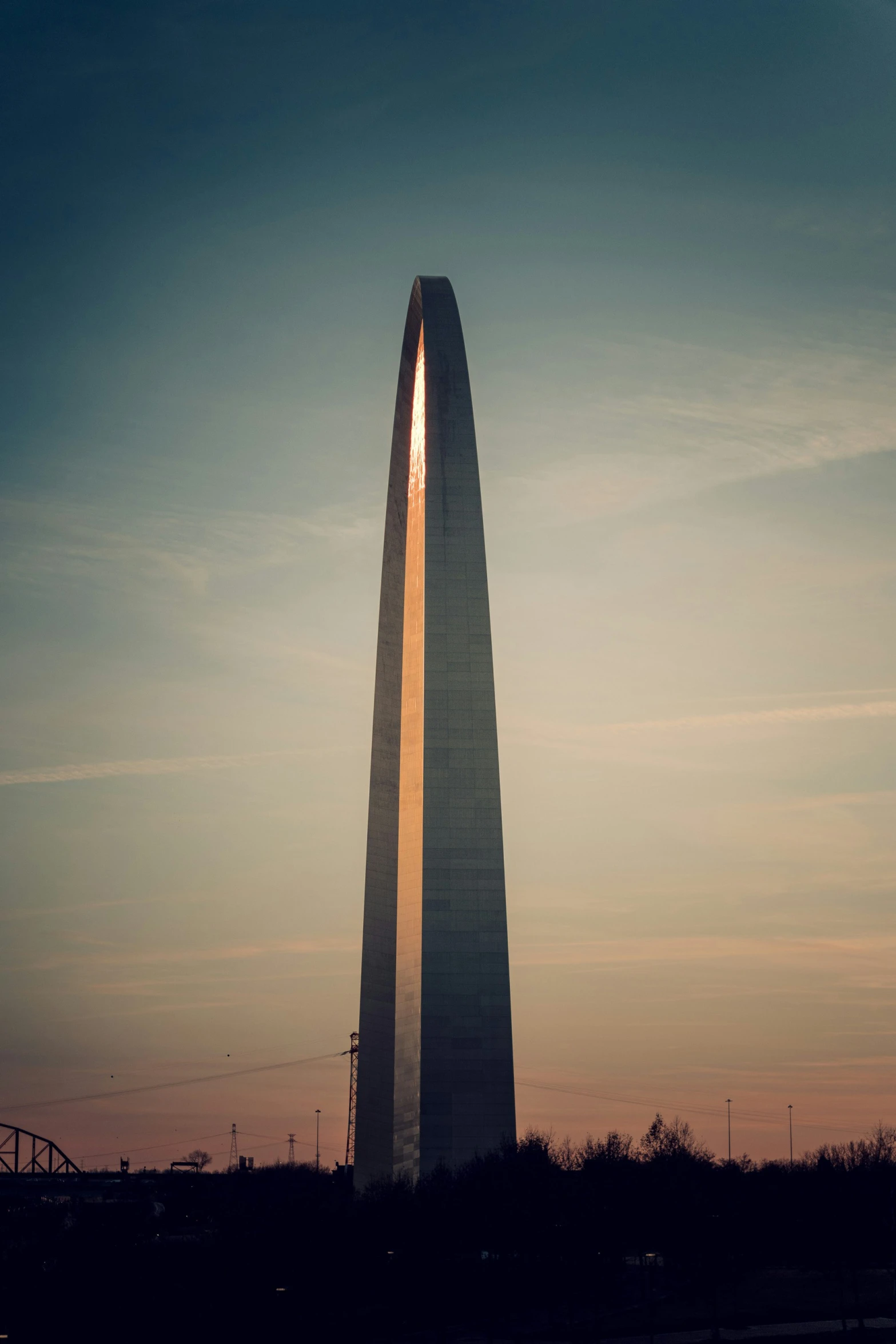 the sun shines bright behind a large monument