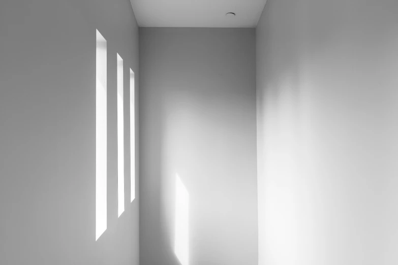 a window on the wall and a white floor